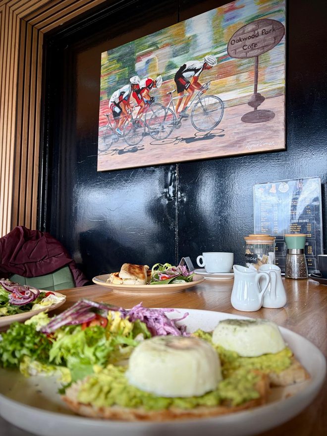 Plates of salad on an indoor table against a dark wall