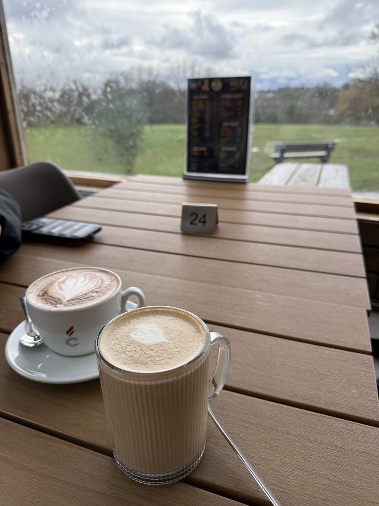 A cappuccino with latte art on an outdoor table